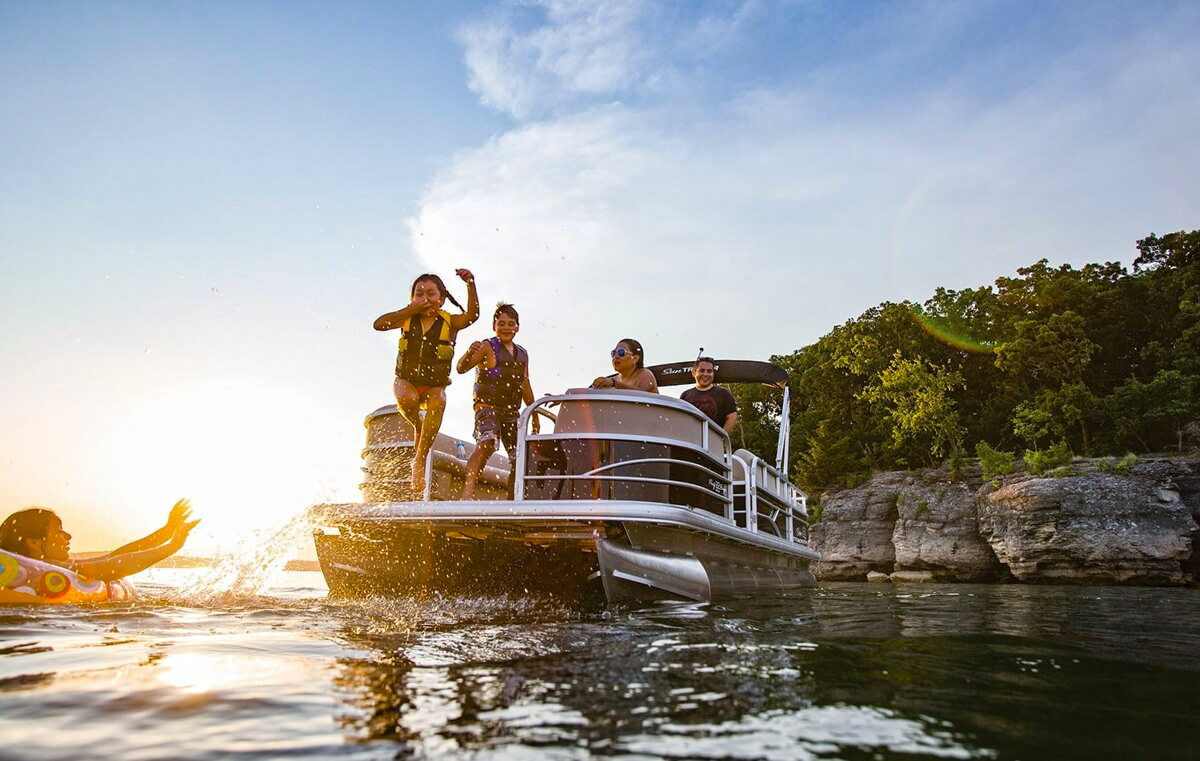 Family on a pontoon on a lake.